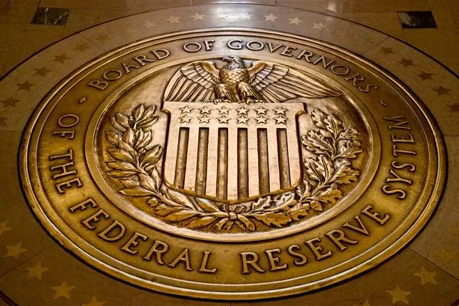 A February 2018 file photo of the seal of the Board of Governors of the United States Federal Reserve System at the Federal Reserve Board Building in Washington. Federal Reserve Governor Christopher Waller has said that the U.S. central bank needs to raise rates aggressively to fight inflation, but not so abruptly as to stress markets, destroy jobs and push the economy into recession. (data credit: Andrew Harnik, AP)