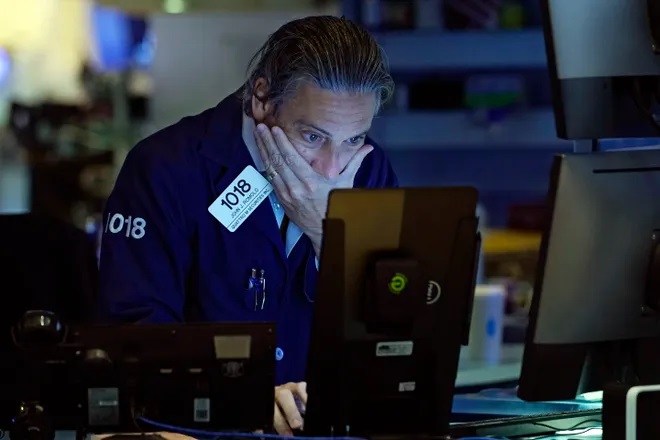 Trader John Romolo works on the floor of the New York Stock Exchange in this Sept. 9, 2021, file photo. The spectacular run for a once-hot investment has fizzled so much that many have been relegated to the bargain bin. These special-purpose acquisition companies, or SPACs, are often called “blank-check companies” because they have no real business other than to hunt for privately owned businesses to buy. (data-c-credit=Richard Drew, AP)