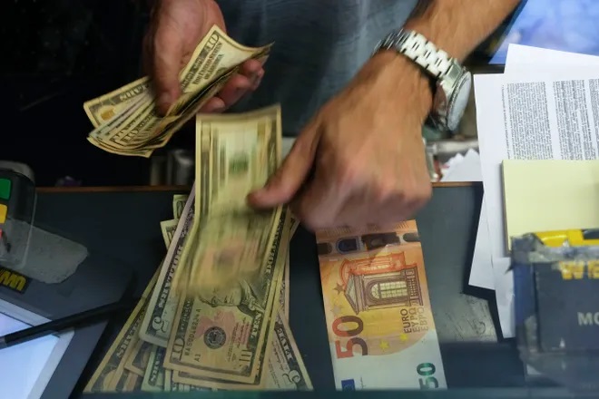 A cashier changes a 50 Euro banknote with U.S. dollars at an exchange counter in Rome on July 13, 2022. Inflation for the European countries using the euro currency hit another record in August, fueled by soaring energy prices mainly driven by Russia’s war in Ukraine. Annual inflation in the eurozone’s 19 countries rose to 9.1% in August, up from 8.9% recorded in July. (Gregorio Borgia, AP)