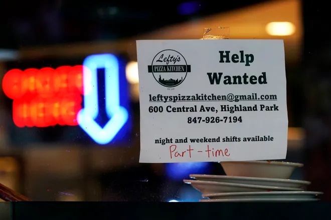 A hiring sign is displayed at a restaurant in Highland Park, Ill., on July 14, 2022. The nation's job market last month delivered just what the Federal Reserve and nervous investors had hoped for — a Goldilocks-style hiring report. Job growth was solid — not too hot, not too cold. And more Americans began looking for work, which could ease worker shortages over time and defuse some of the inflationary pressures that the Fed has made its No. 1 mission. (Nam Y. Huh, AP)