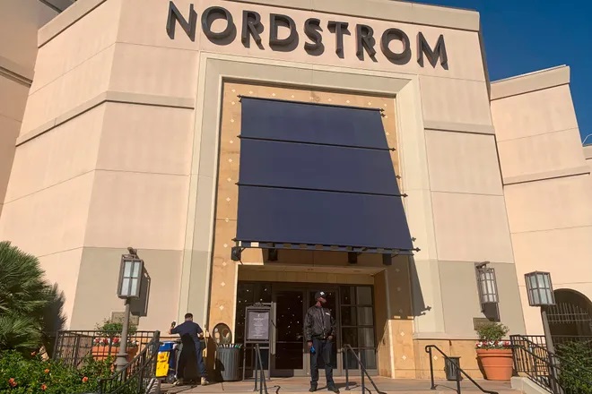 A security guard stands outside the Nordstrom store at The Grove retail and entertainment complex in Los Angeles on Nov. 23, 2021. California Retailers Association president Rachel Michelin says shoplifting has been a growing problem. (AP Photo/Eugene Garcia, File)