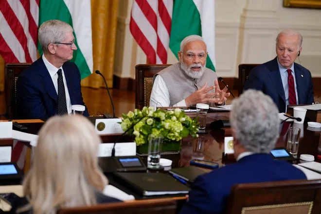 India's Prime Minister Narendra Modi speaks during a meeting with President Joe Biden and American and Indian business leaders in the East Room of the White House, Friday, June 23, 2023, in Washington. Tim Cook, CEO of Apple, listens at left. (AP Photo/Evan Vucci)