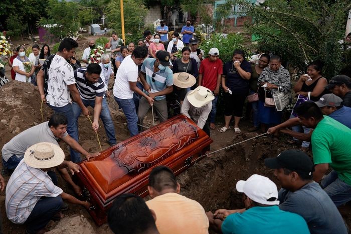 Residents burying Wilmer Rojas who was killed during a 2022 attack by a drug gang that fatally shot 20 people in the state of Guerrero, Mexico (AP Photo/ Eduardo Verdugo)